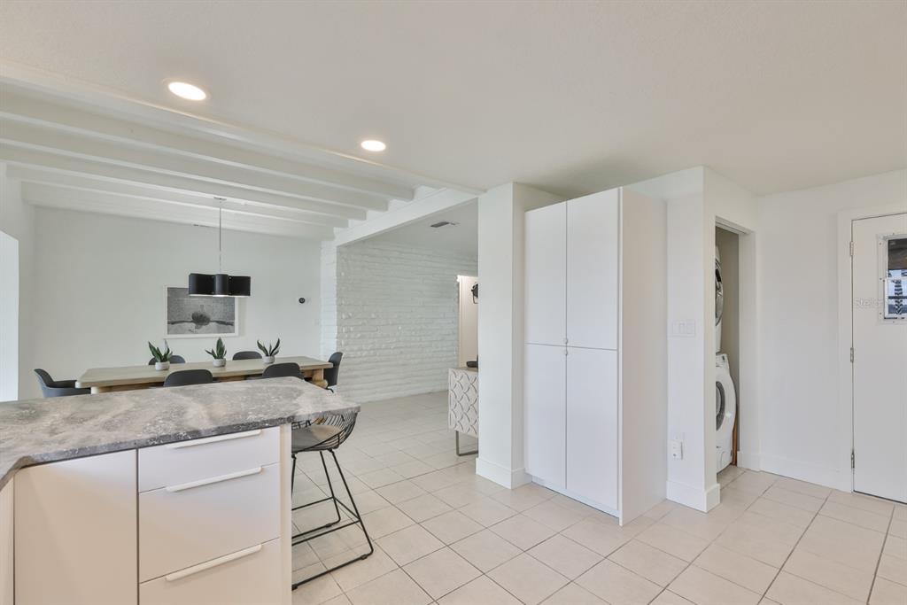 387 12th Avenue Indian Rocks Beach, FL 33785 - Photo 31 of 44 a kitchen with a sink cabinets and refrigerator