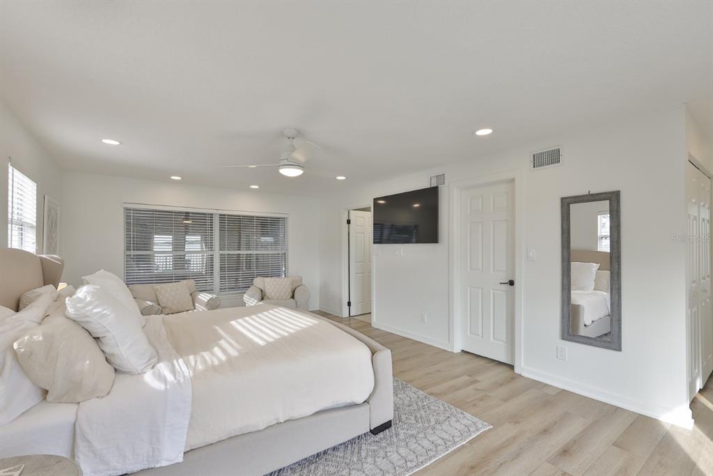 387 12th Avenue Indian Rocks Beach, FL 33785 - Photo 34 of 44 a bedroom with a large bed and a tv