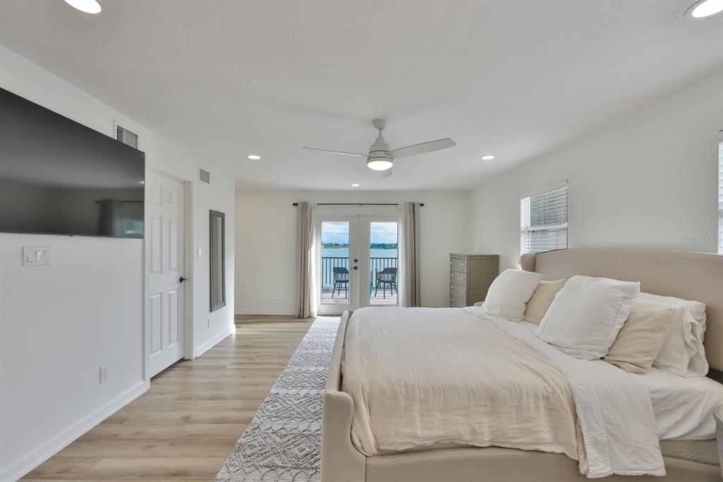 387 12th Avenue Indian Rocks Beach, FL 33785 - Photo 35 of 44 a spacious bedroom with a large bed and a large window
