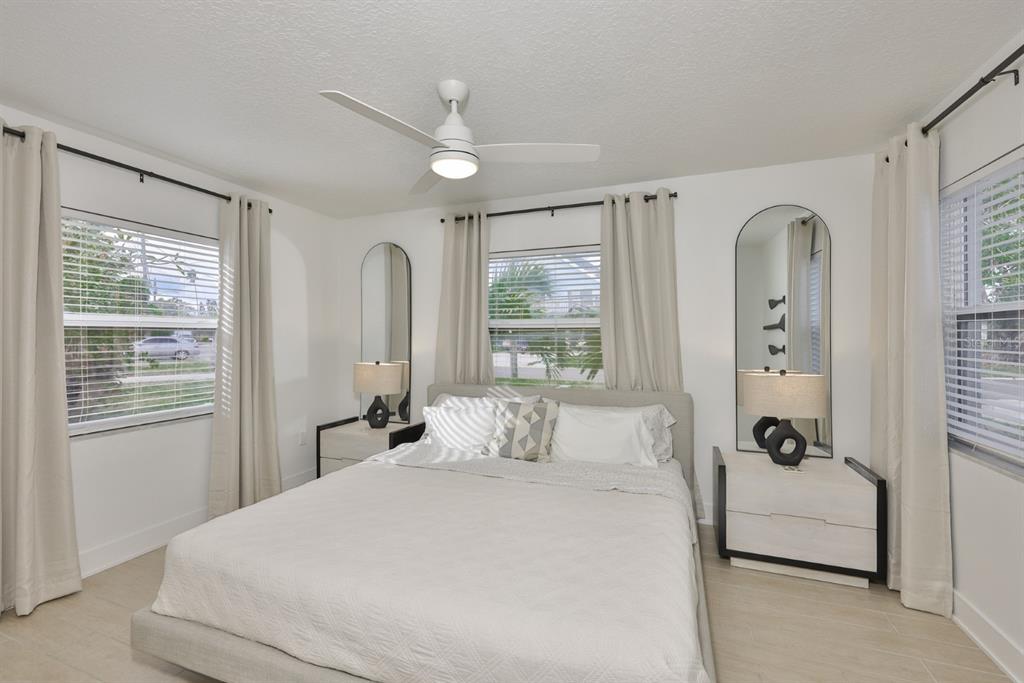 387 12th Avenue Indian Rocks Beach, FL 33785 - Photo 38 of 44 a bedroom with a large bed and a window