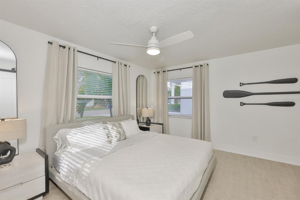 387 12th Avenue Indian Rocks Beach, FL 33785 - Photo 39 of 44 a bedroom with a large bed and a chandelier