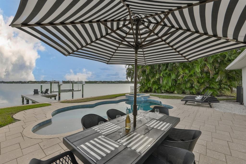 387 12th Avenue Indian Rocks Beach, FL 33785 - Photo 8 of 44 a view of a patio with table and chairs and potted plants