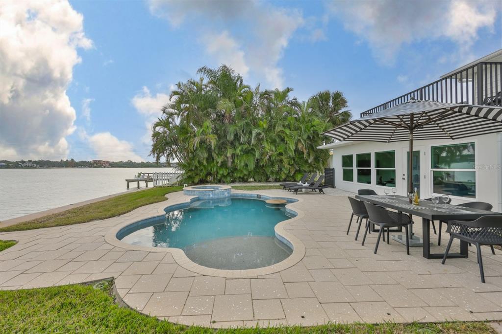 387 12th Avenue Indian Rocks Beach, FL 33785 - Photo 9 of 44 a view of a swimming pool with outdoor seating