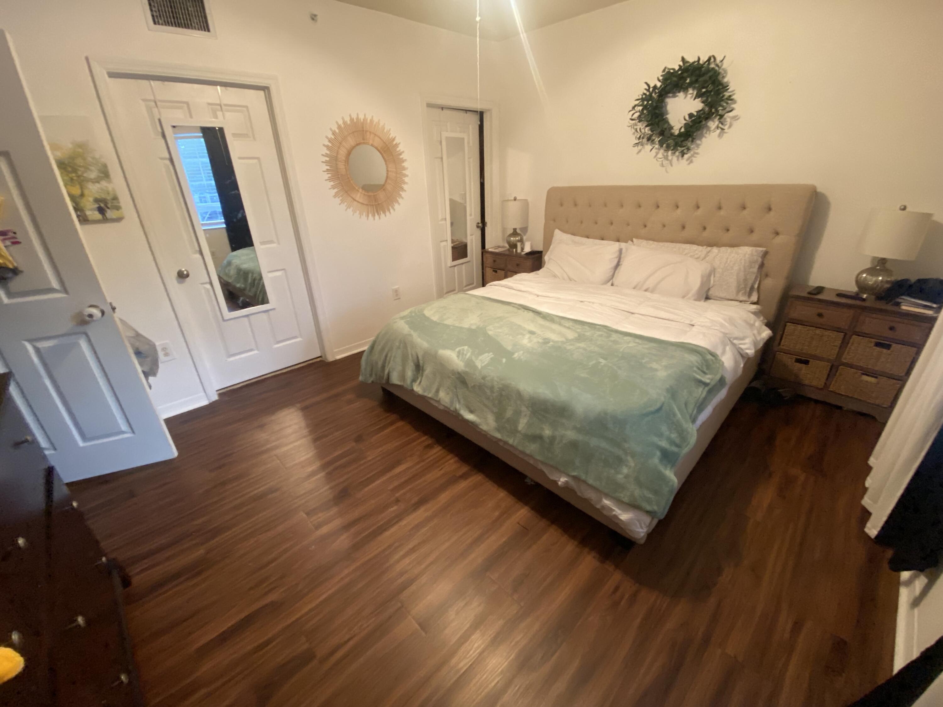 6511 Emerald Dunes Drive, Unit 208 West Palm Beach, FL 33411 - Photo 21 of 51 a bedroom with a bed and a mirror