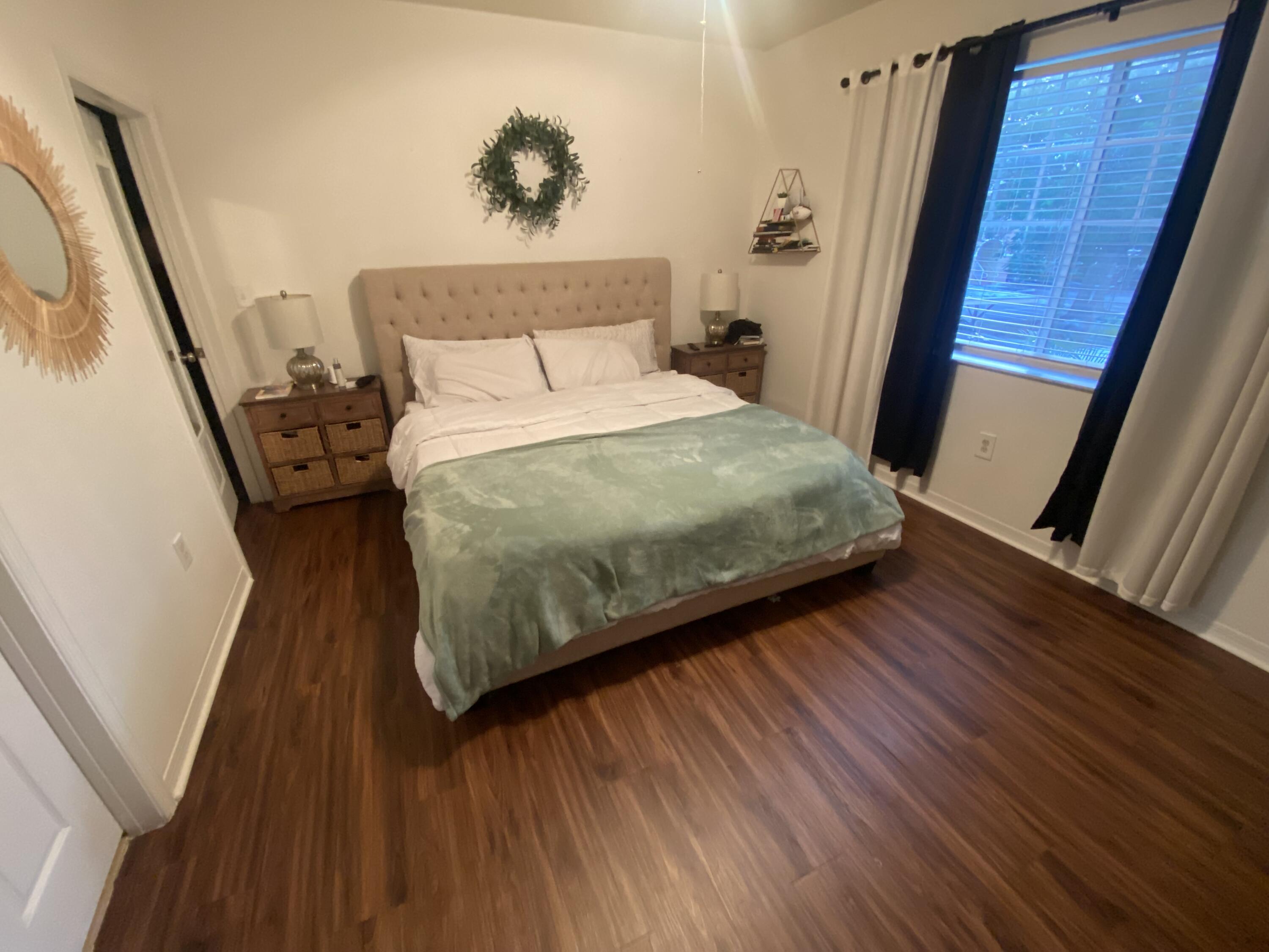 6511 Emerald Dunes Drive, Unit 208 West Palm Beach, FL 33411 - Photo 22 of 51 a bedroom with a bed and a mirror on the dresser