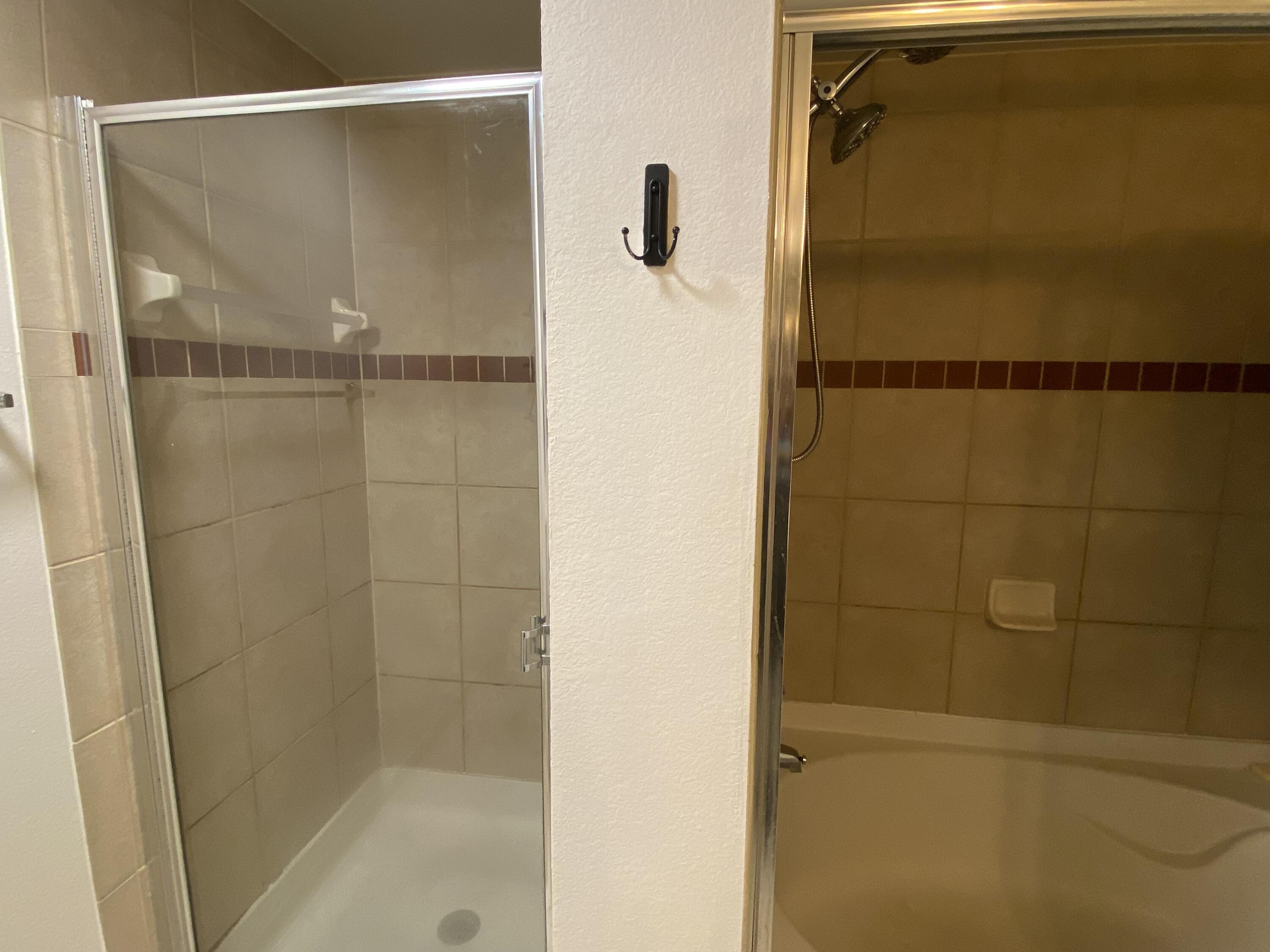 6511 Emerald Dunes Drive, Unit 208 West Palm Beach, FL 33411 - Photo 26 of 51 a bathroom with a glass shower door