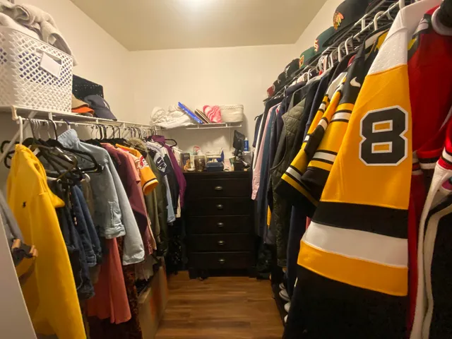 a view of a bedroom with furniture and window