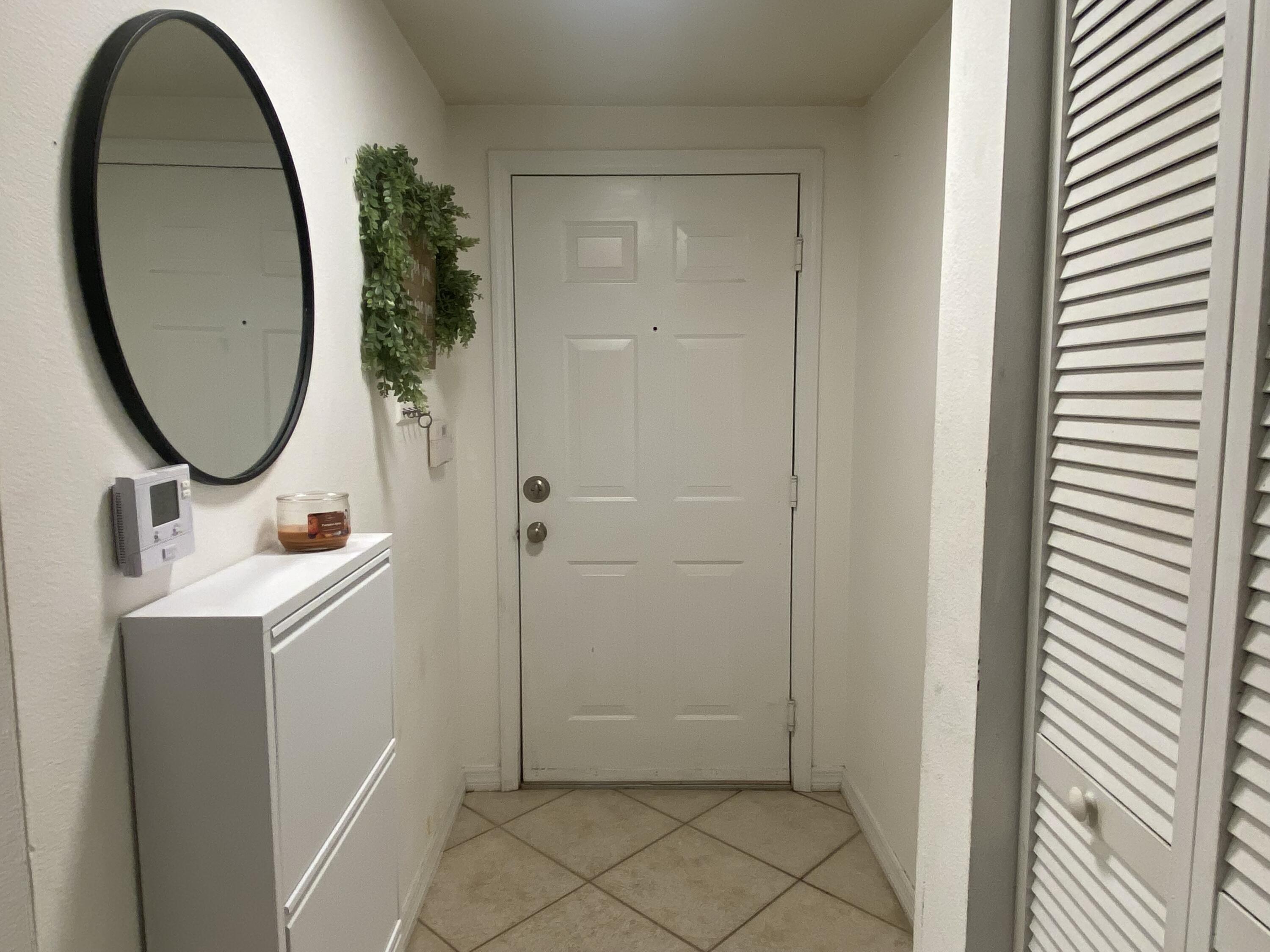 6511 Emerald Dunes Drive, Unit 208 West Palm Beach, FL 33411 - Photo 3 of 51 a bathroom with a sink and a mirror