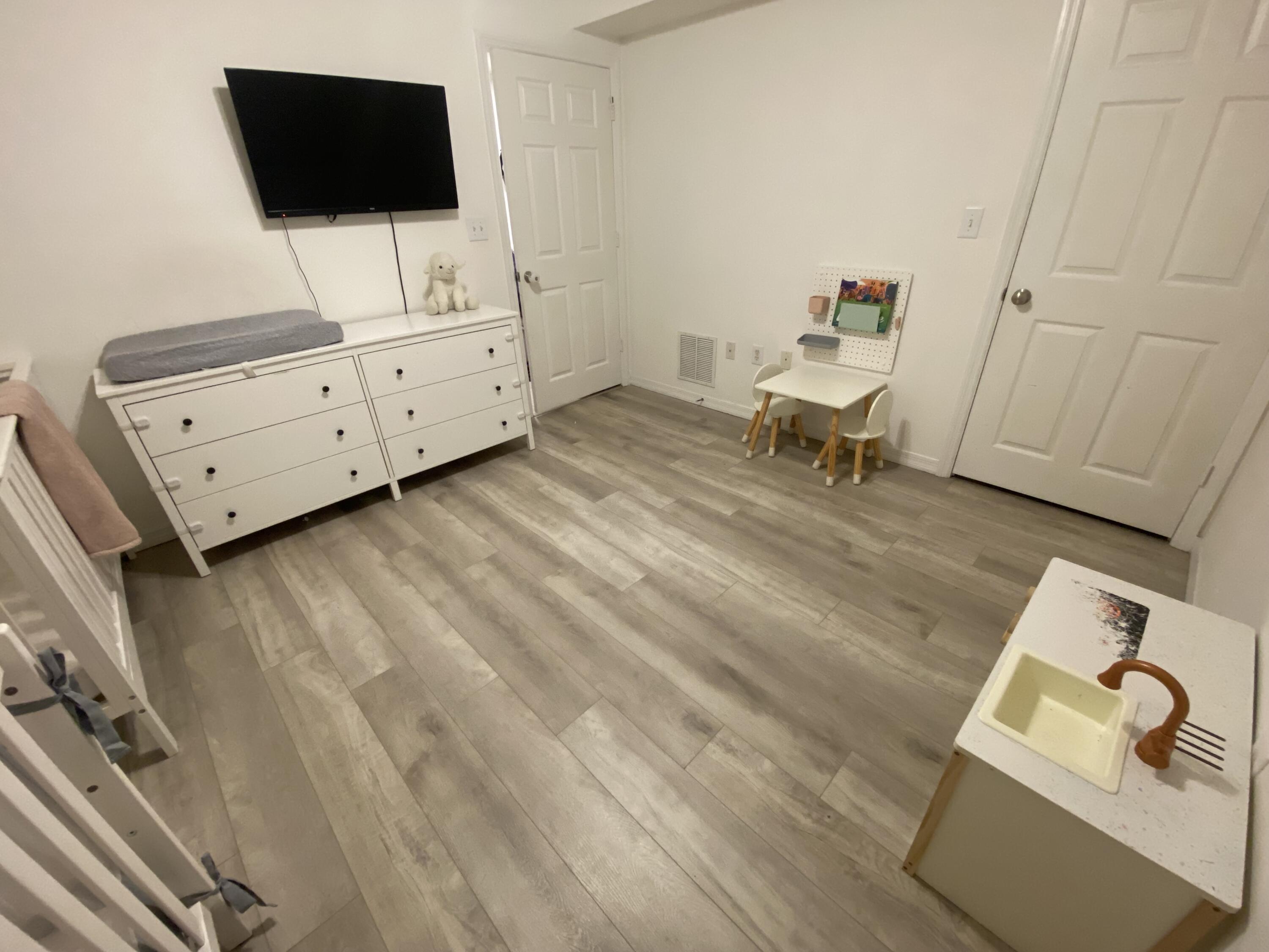 6511 Emerald Dunes Drive, Unit 208 West Palm Beach, FL 33411 - Photo 35 of 51 a living room with furniture and a flat screen tv