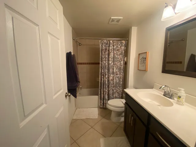 a bathroom with a sink mirror and toilet