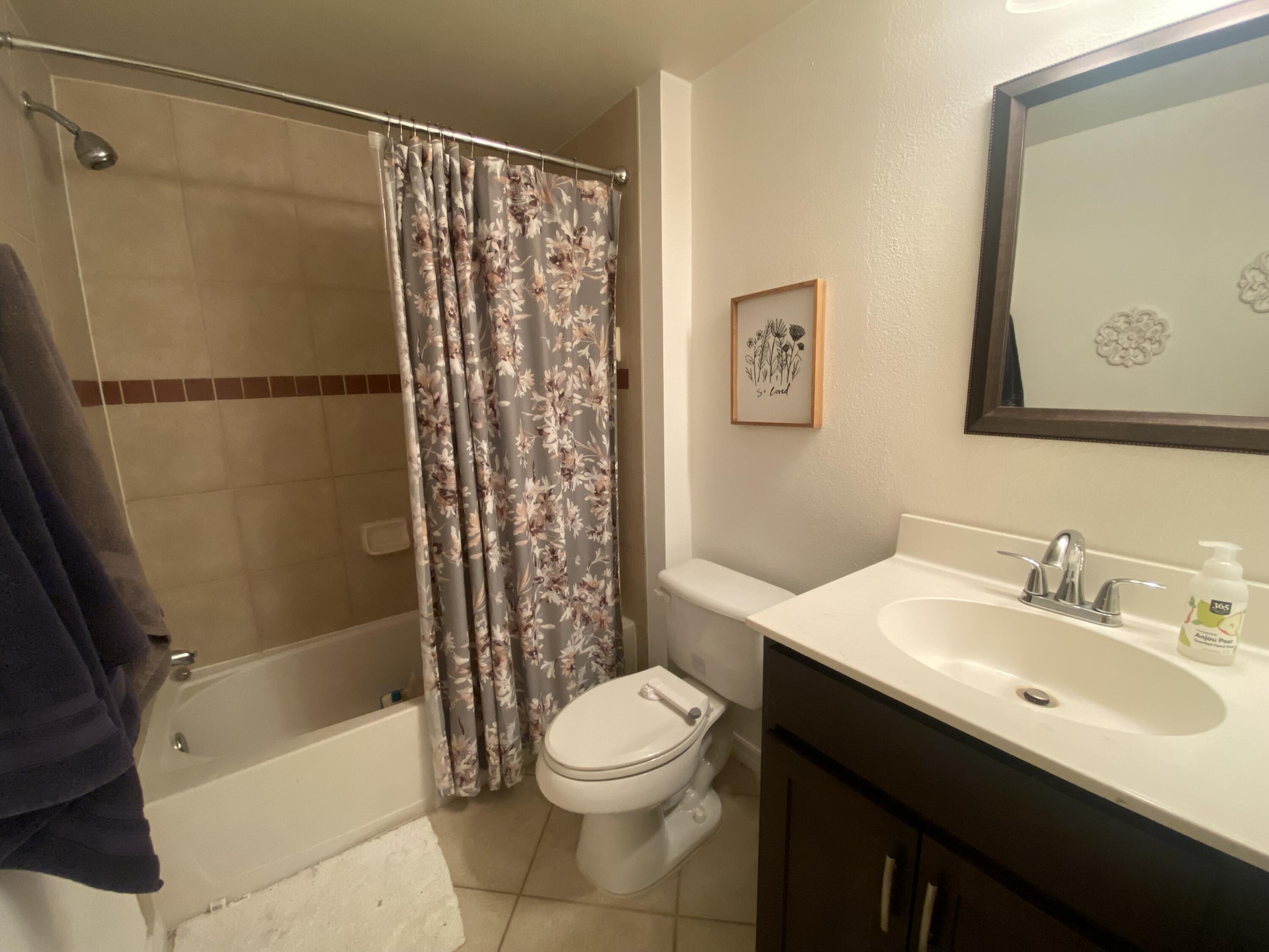 6511 Emerald Dunes Drive, Unit 208 West Palm Beach, FL 33411 - Photo 39 of 51 a bathroom with a sink a toilet and shower