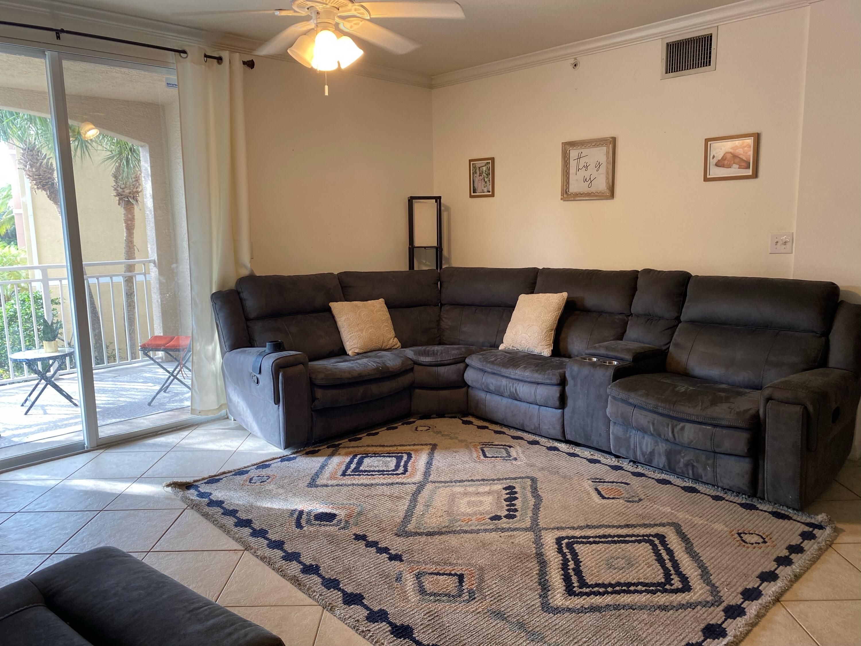 6511 Emerald Dunes Drive, Unit 208 West Palm Beach, FL 33411 - Photo 4 of 51 a living room with furniture and a fireplace