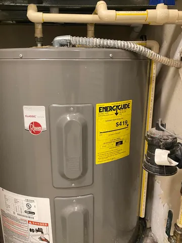 a view of pool with lawn chairs and plants