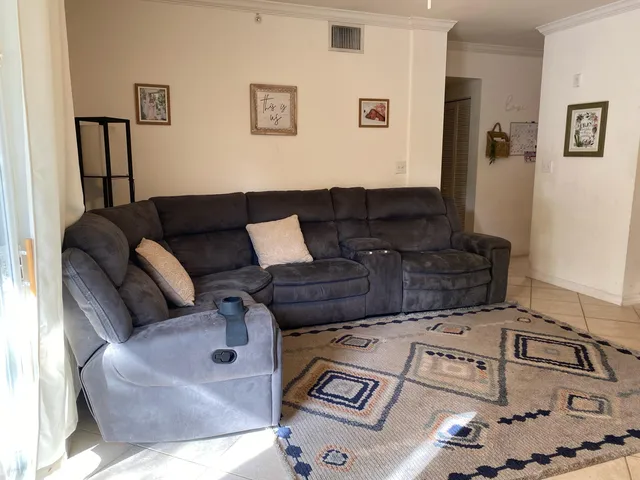 a living room with furniture and flat screen tv