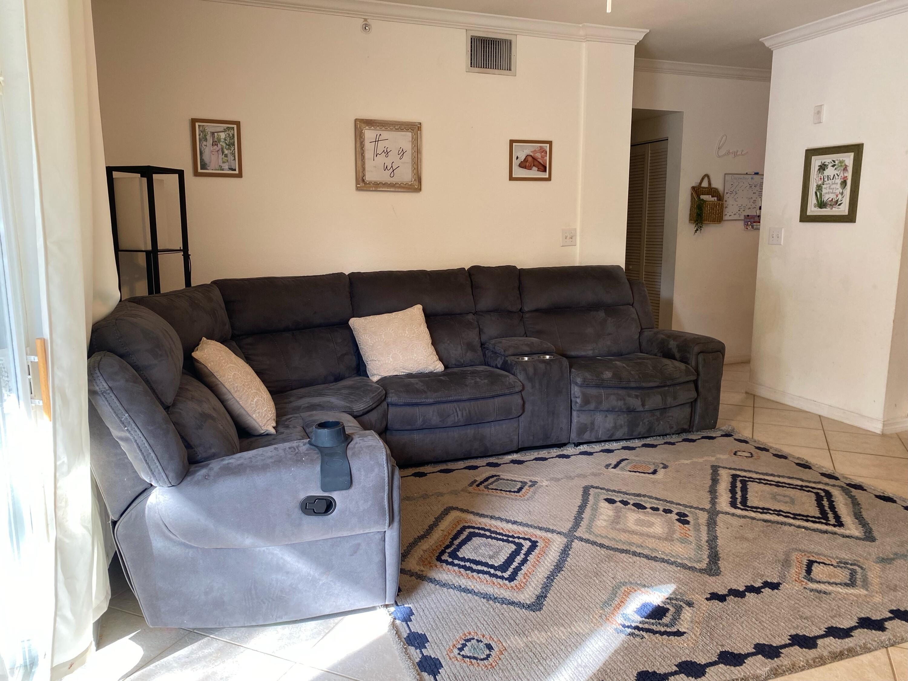 6511 Emerald Dunes Drive, Unit 208 West Palm Beach, FL 33411 - Photo 5 of 51 a living room with furniture and a couch