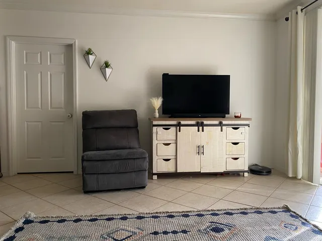 a living room with furniture and a lamp