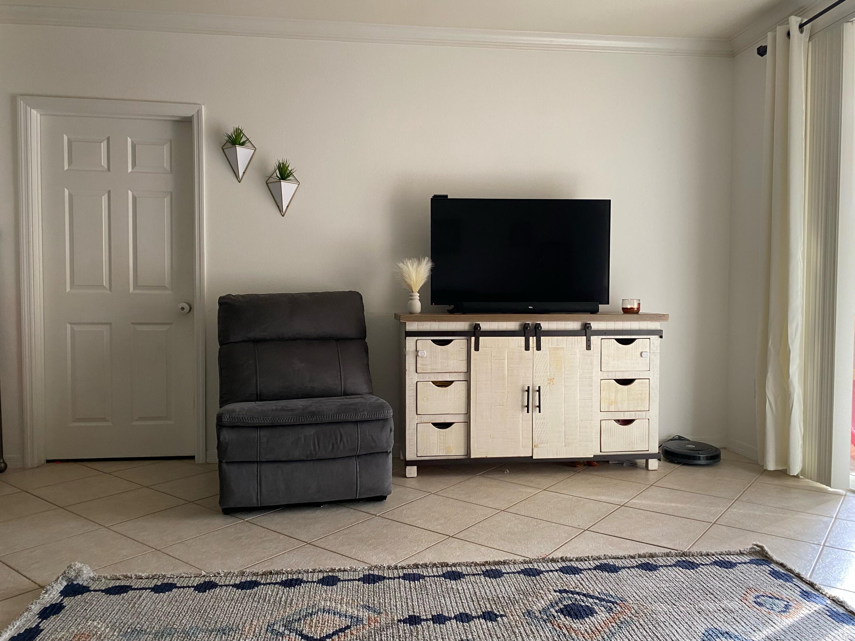 6511 Emerald Dunes Drive, Unit 208 West Palm Beach, FL 33411 - Photo 6 of 51 a living room with furniture and flat screen tv