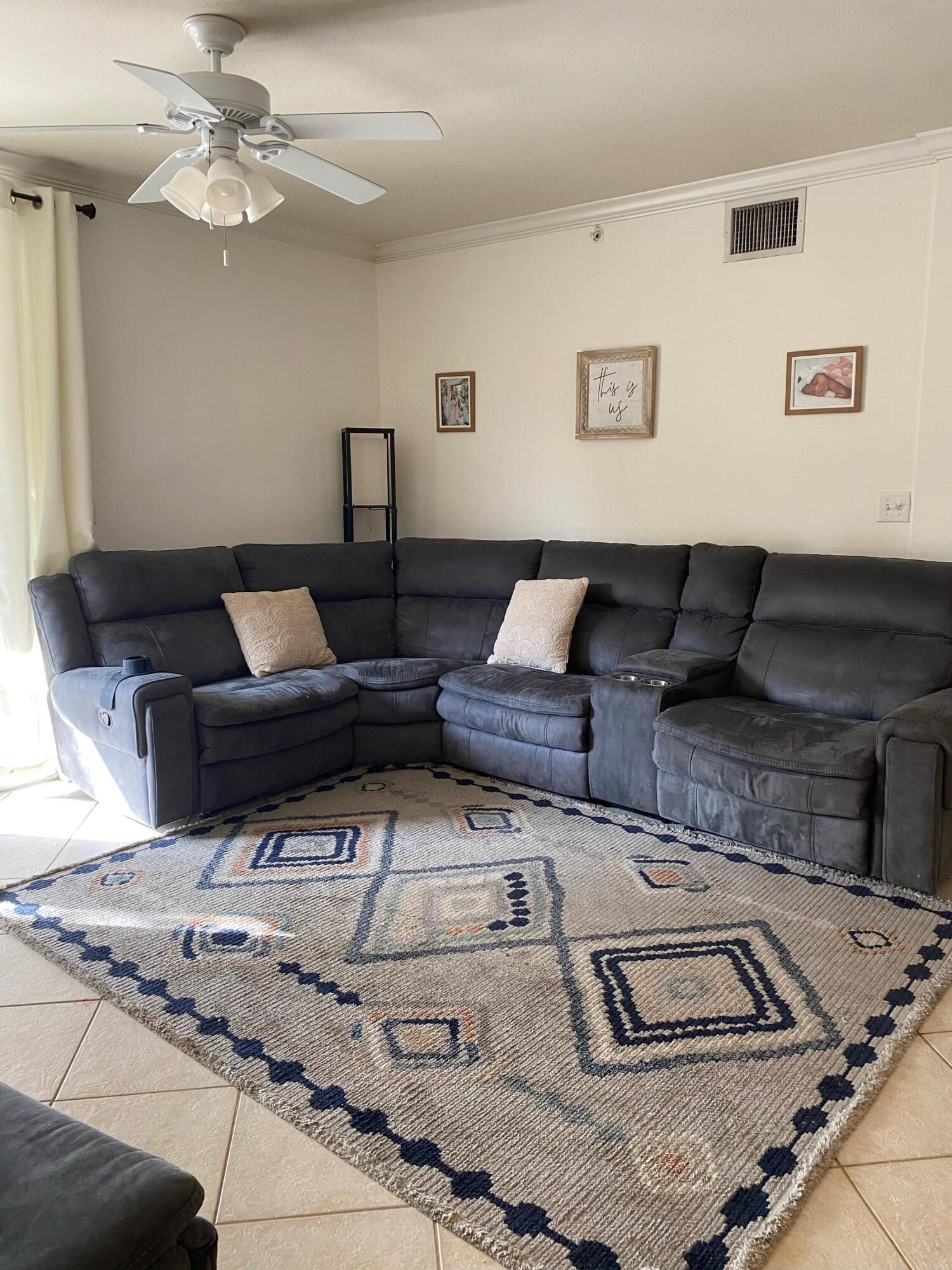 6511 Emerald Dunes Drive, Unit 208 West Palm Beach, FL 33411 - Photo 7 of 51 a living room with furniture and a lamp