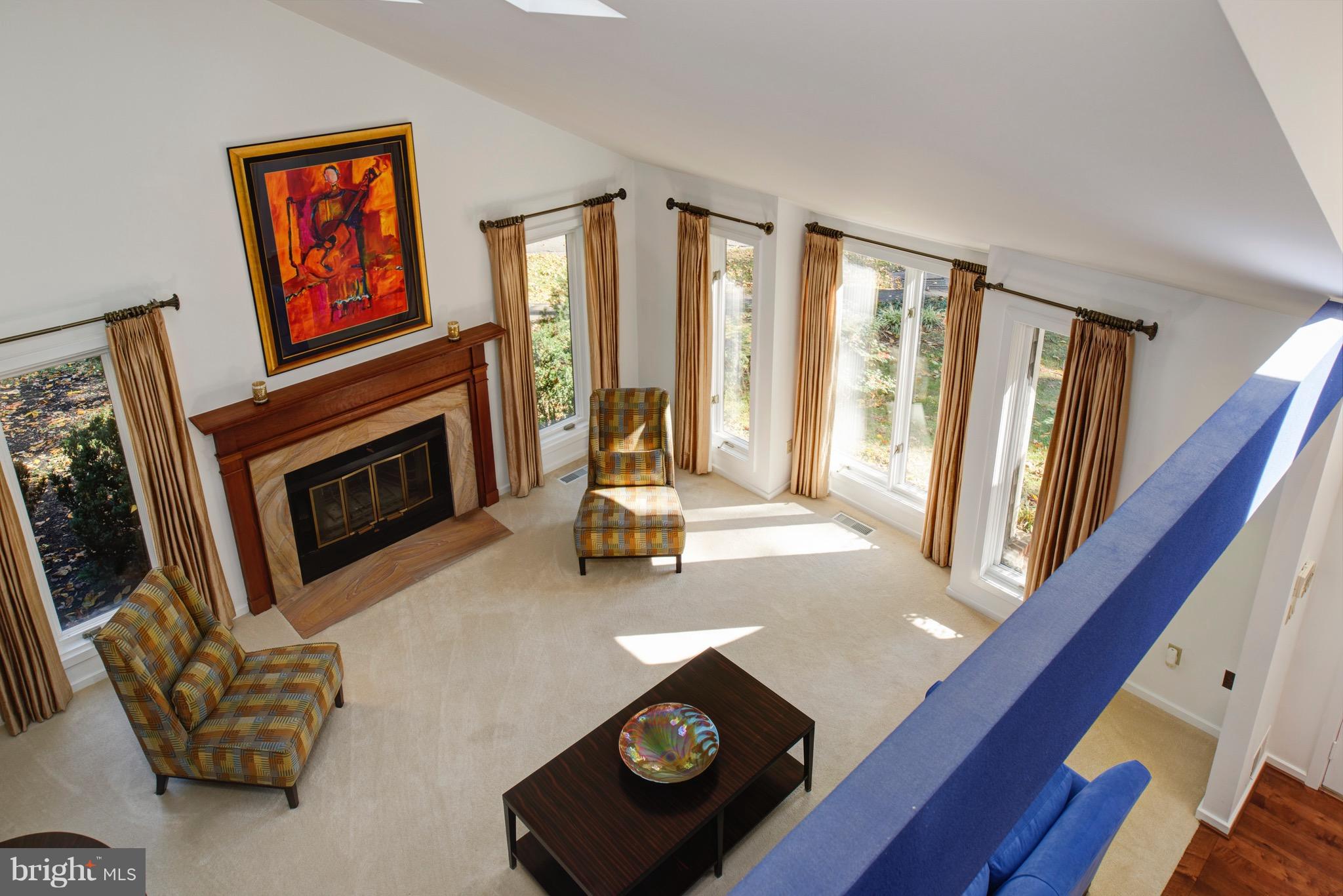 11400 Fieldstone Lane Reston, VA 20191 - Photo 6 of 28 a living room with furniture a fireplace and a flat screen tv