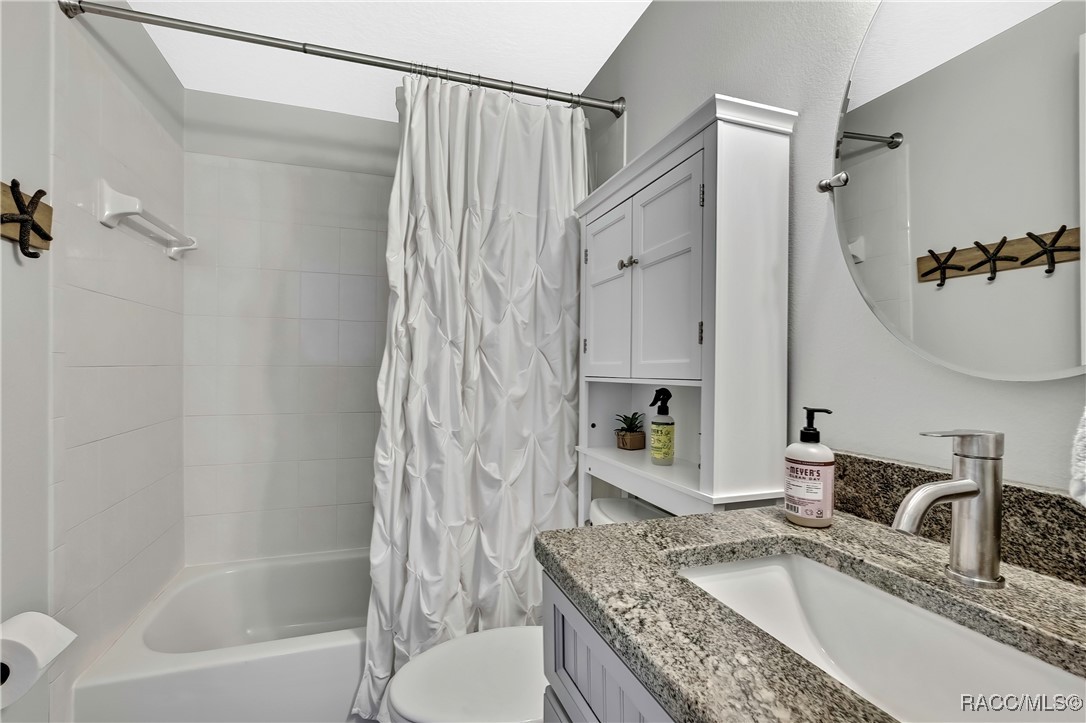 2855 North Rivers Edge Boulevard, Unit 213 Crystal River, FL 34429 - Photo 34 of 62 a bathroom with a granite countertop sink a toilet and shower