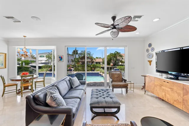 a living room with furniture a flat screen tv and a large window