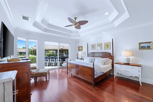 a spacious bedroom with a bed and a large window