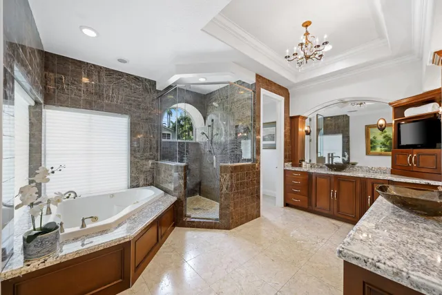 a spacious bathroom with a tub double sink and mirror