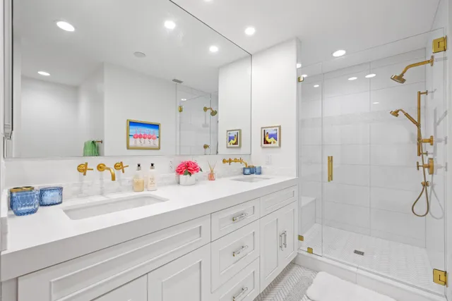 a bathroom with a shower sink and a mirror