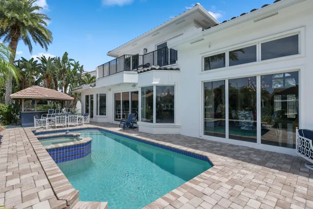 a view of a house with swimming pool and sitting area