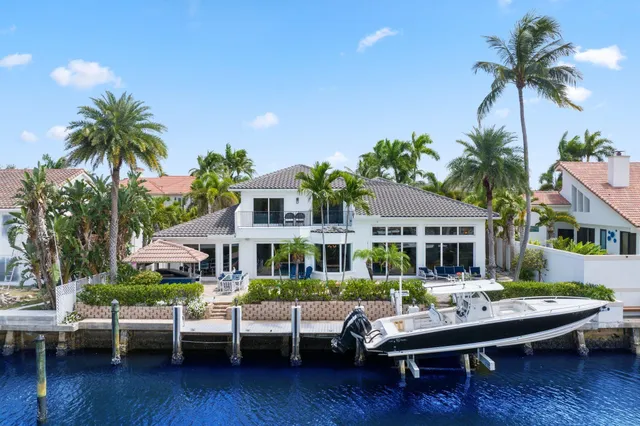 a view of a house with backyard sitting area and swimming pool