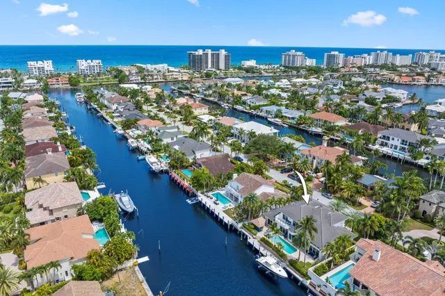 a front view of a house with swimming pool garden and patio