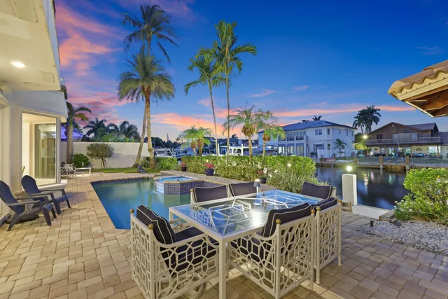 an aerial view of residential houses with outdoor space and swimming pool