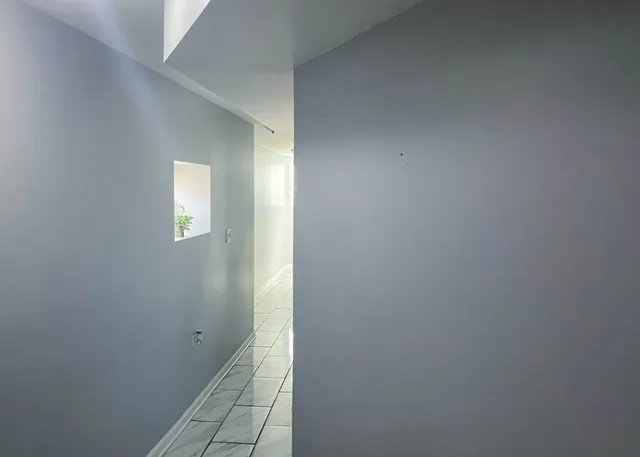 a view of a hallway with wooden floor and entryway