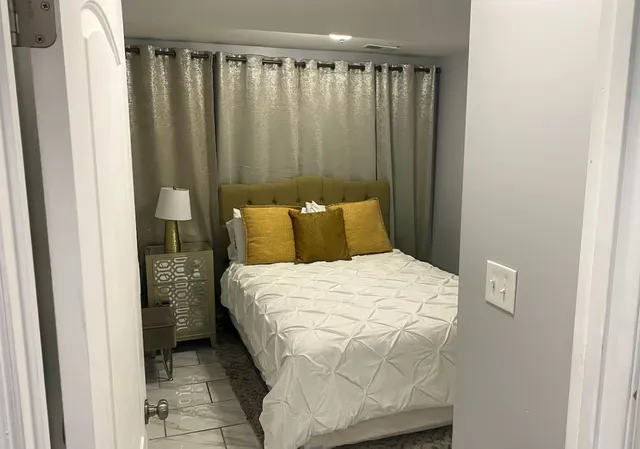 a bedroom with a bed and a window