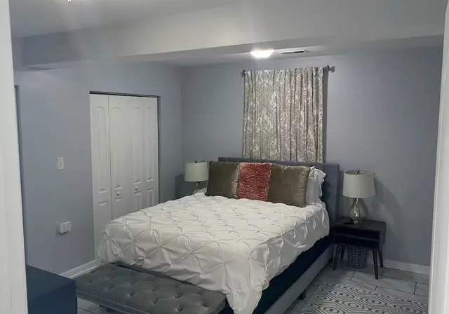 a bedroom with a bed and a flat screen tv