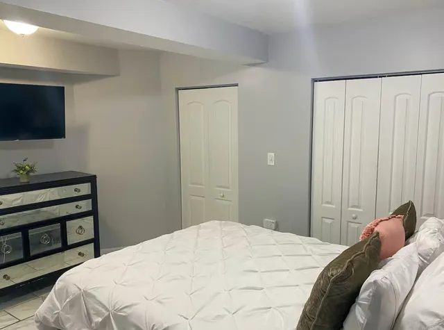 a bedroom with a bed and a painting on the wall
