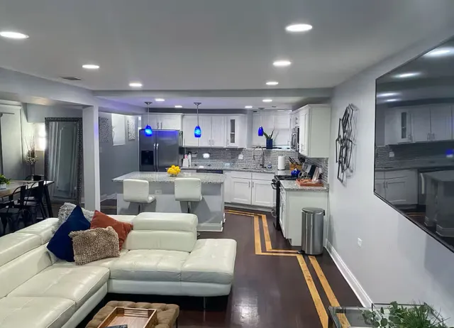 a living room with furniture and kitchen view