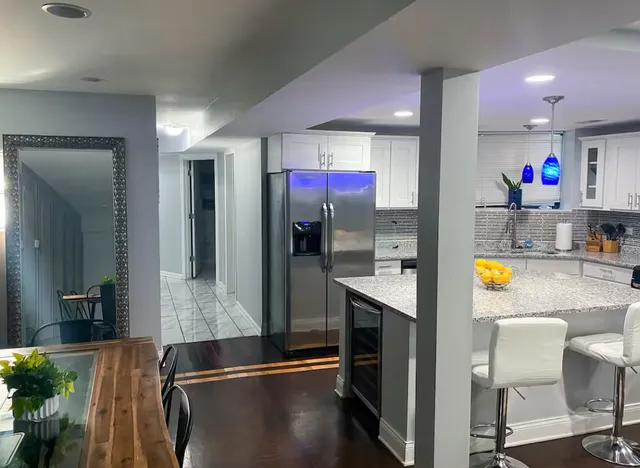 a kitchen with stainless steel appliances granite countertop a refrigerator a oven and a sink