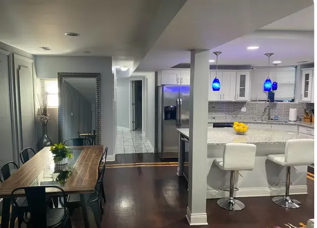 a dining room with furniture and wooden floor