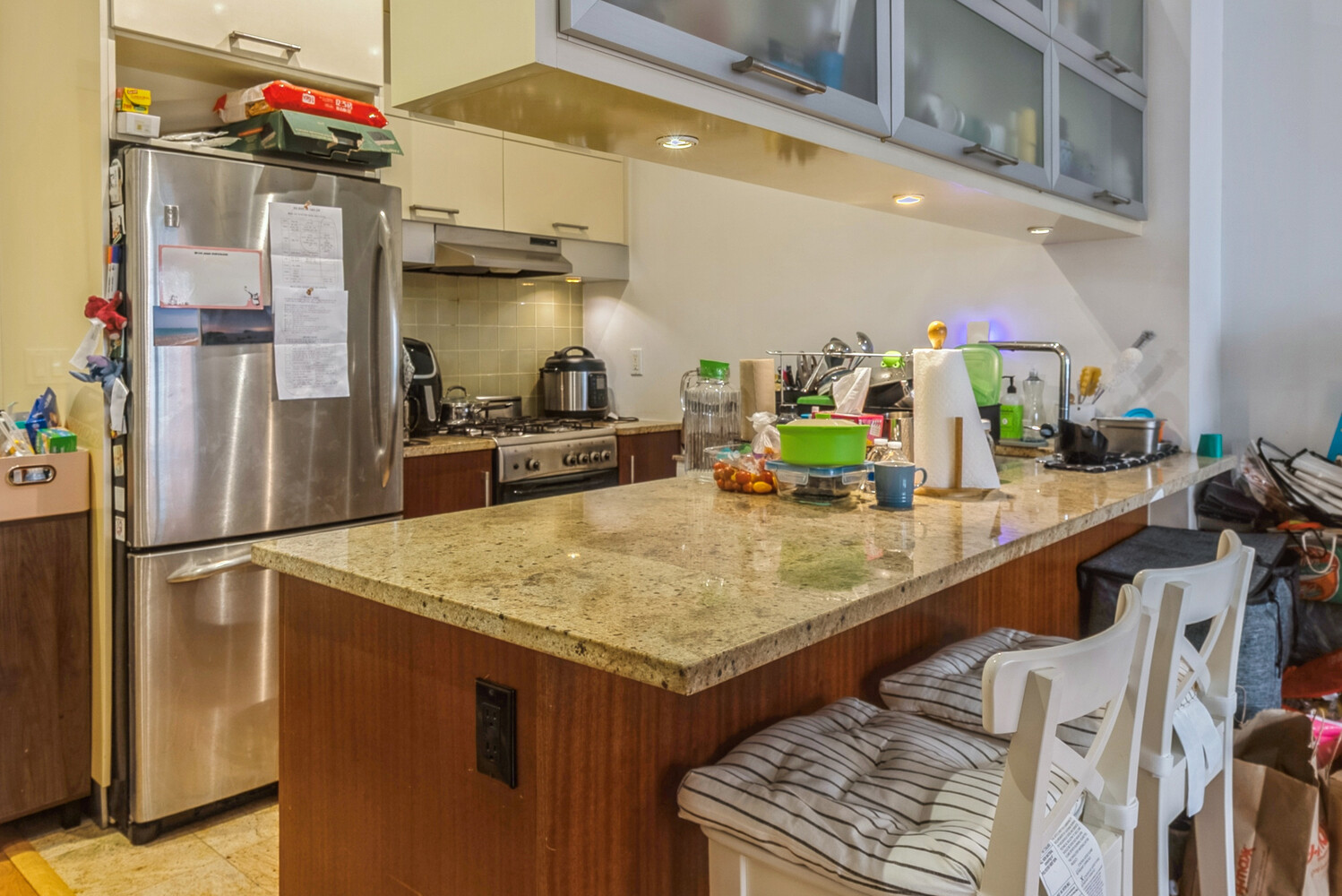 41-26 27th Street, Unit 8B Queens, NY 11101 - Photo 3 of 11 a kitchen with stainless steel appliances granite countertop a sink and a refrigerator
