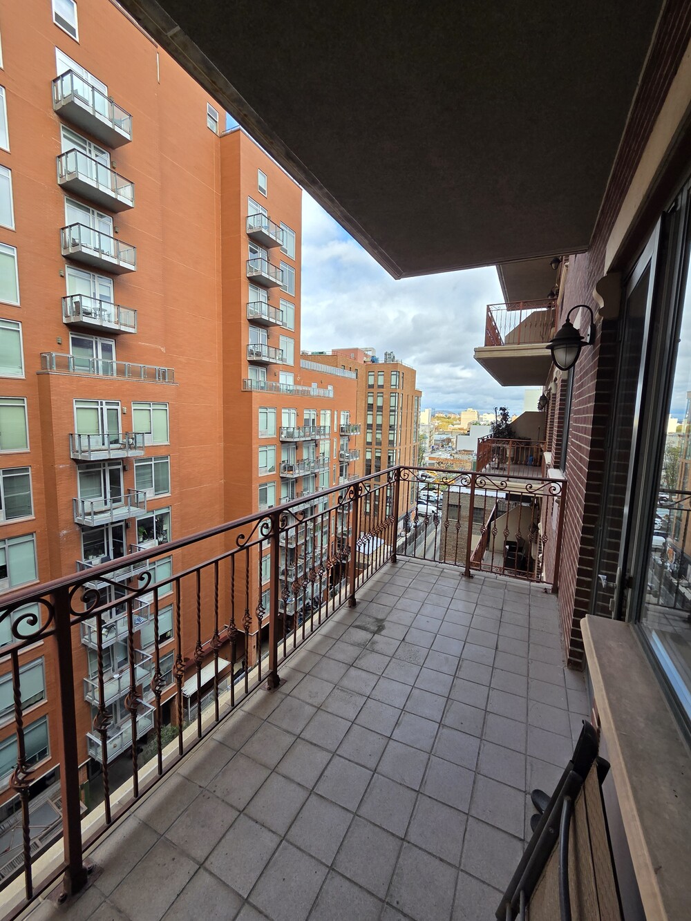 41-26 27th Street, Unit 8B Queens, NY 11101 - Photo 6 of 11 a view of a balcony with chairs