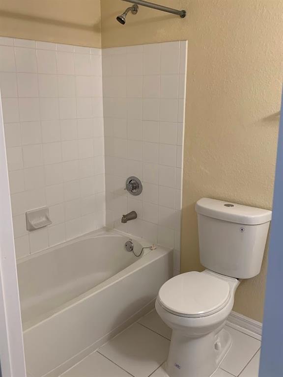 2565 Centergate Drive, Unit 204 Miramar, FL 33025 - Photo 12 of 30 a white toilet and tub sitting next to a bathroom sink