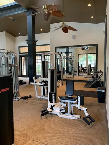 a room with gym equipment and a large window