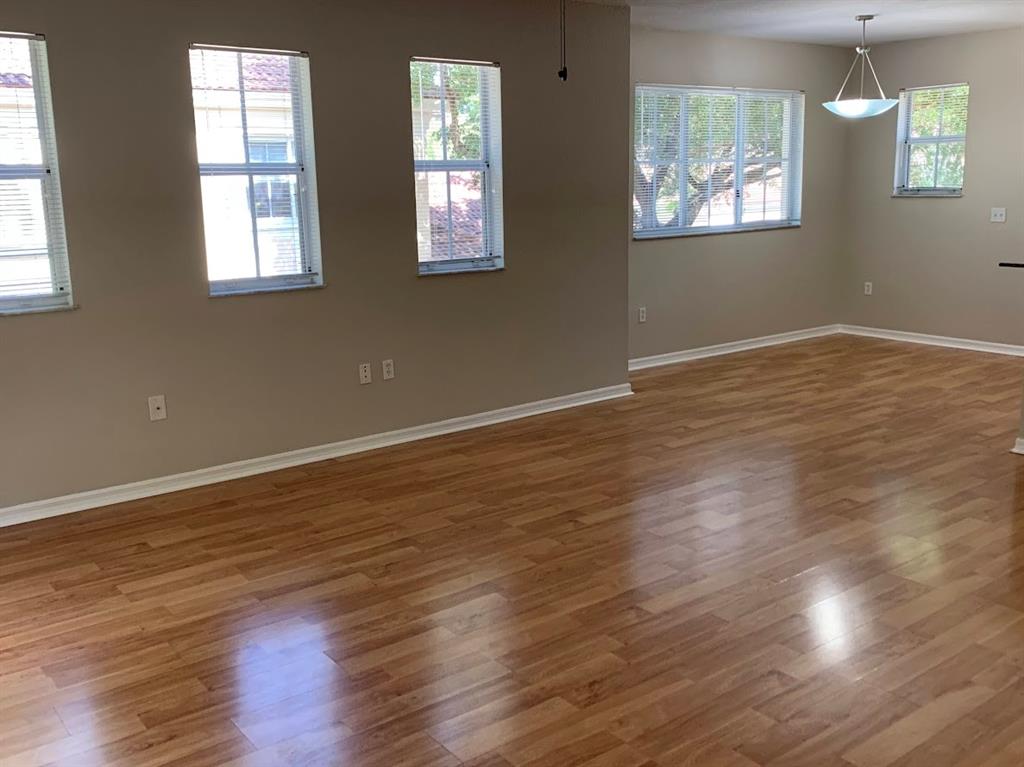 2565 Centergate Drive, Unit 204 Miramar, FL 33025 - Photo 24 of 30 a view of an empty room with wooden floor and a window