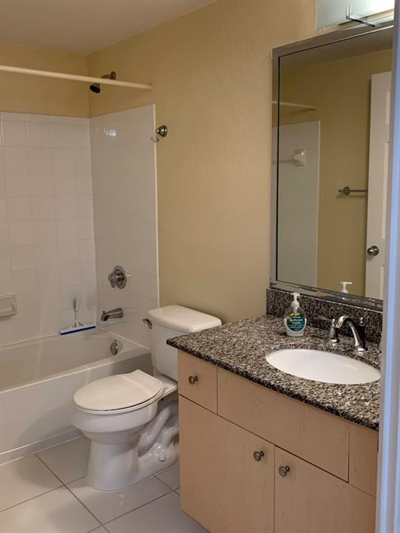 2565 Centergate Drive, Unit 204 Miramar, FL 33025 - Photo 25 of 30 a bathroom with a granite countertop sink a toilet and a mirror