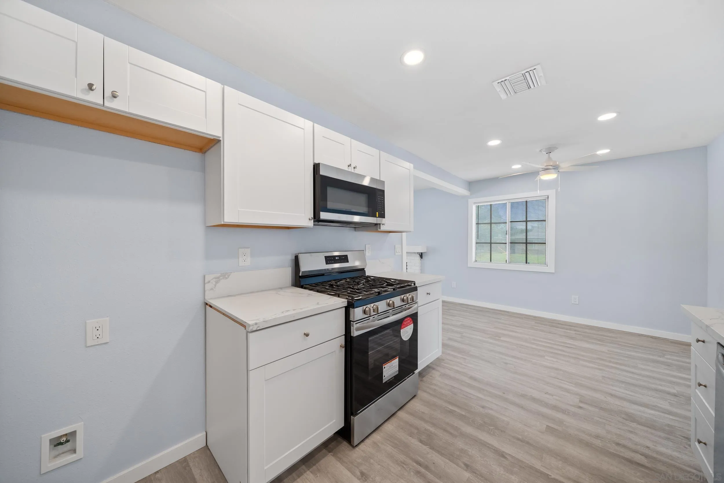 3563 Cannes Avenue Riverside, CA 92501 - Photo 12 of 21 a kitchen with a sink cabinets and wooden floor