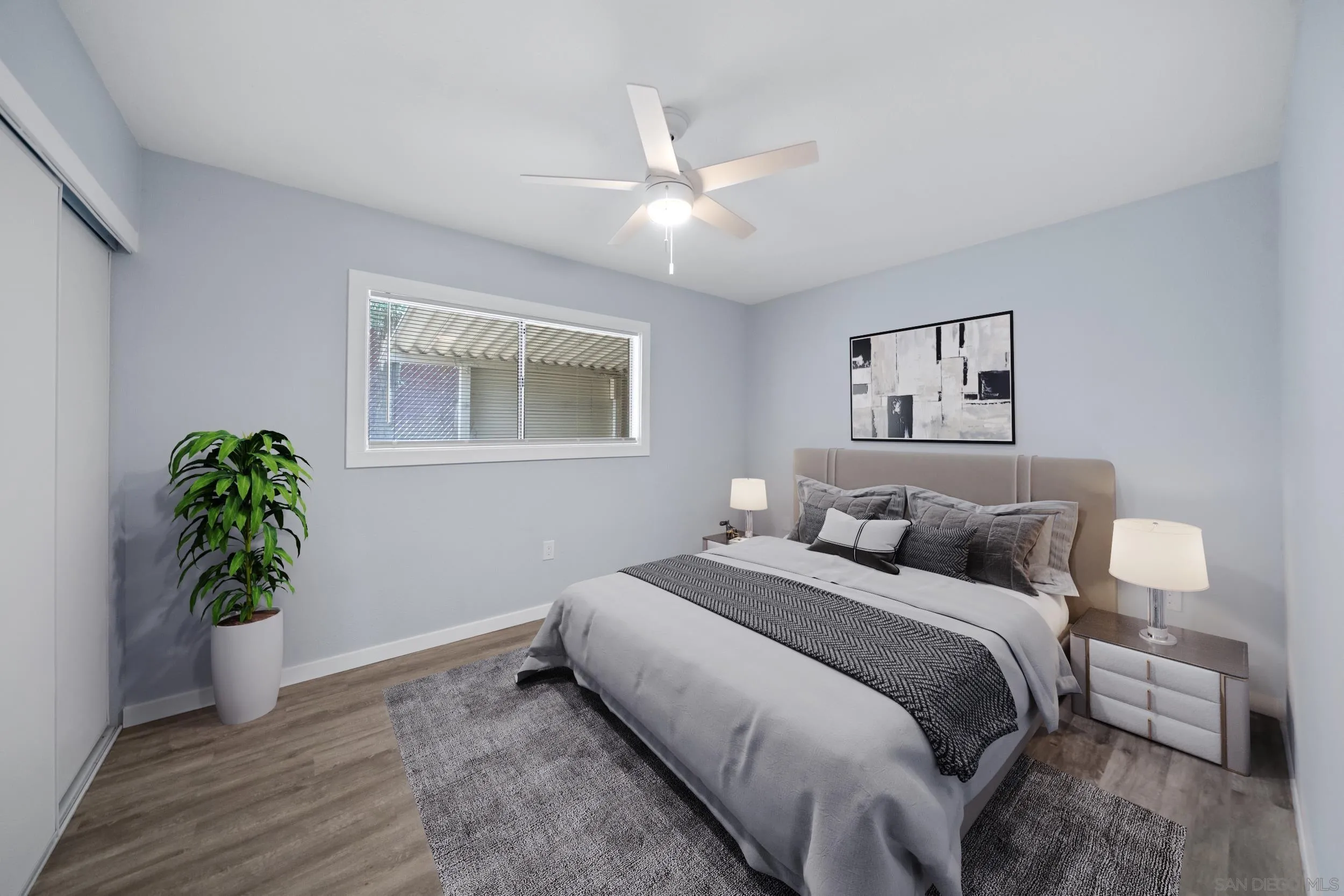 3563 Cannes Avenue Riverside, CA 92501 - Photo 16 of 21 a bedroom with a bed and a potted plant