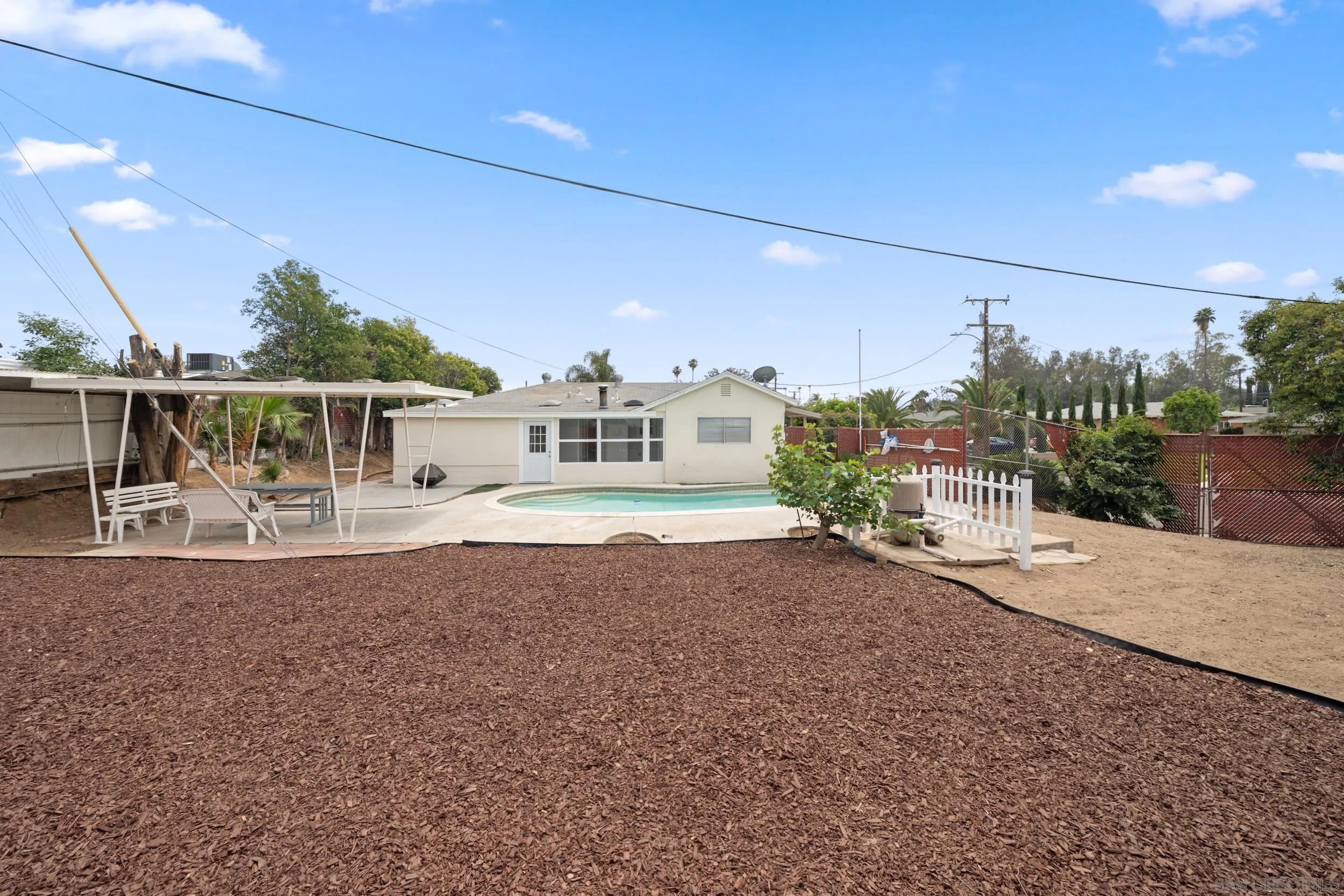 3563 Cannes Avenue Riverside, CA 92501 - Photo 19 of 21 a front view of a house with a yard and potted plants