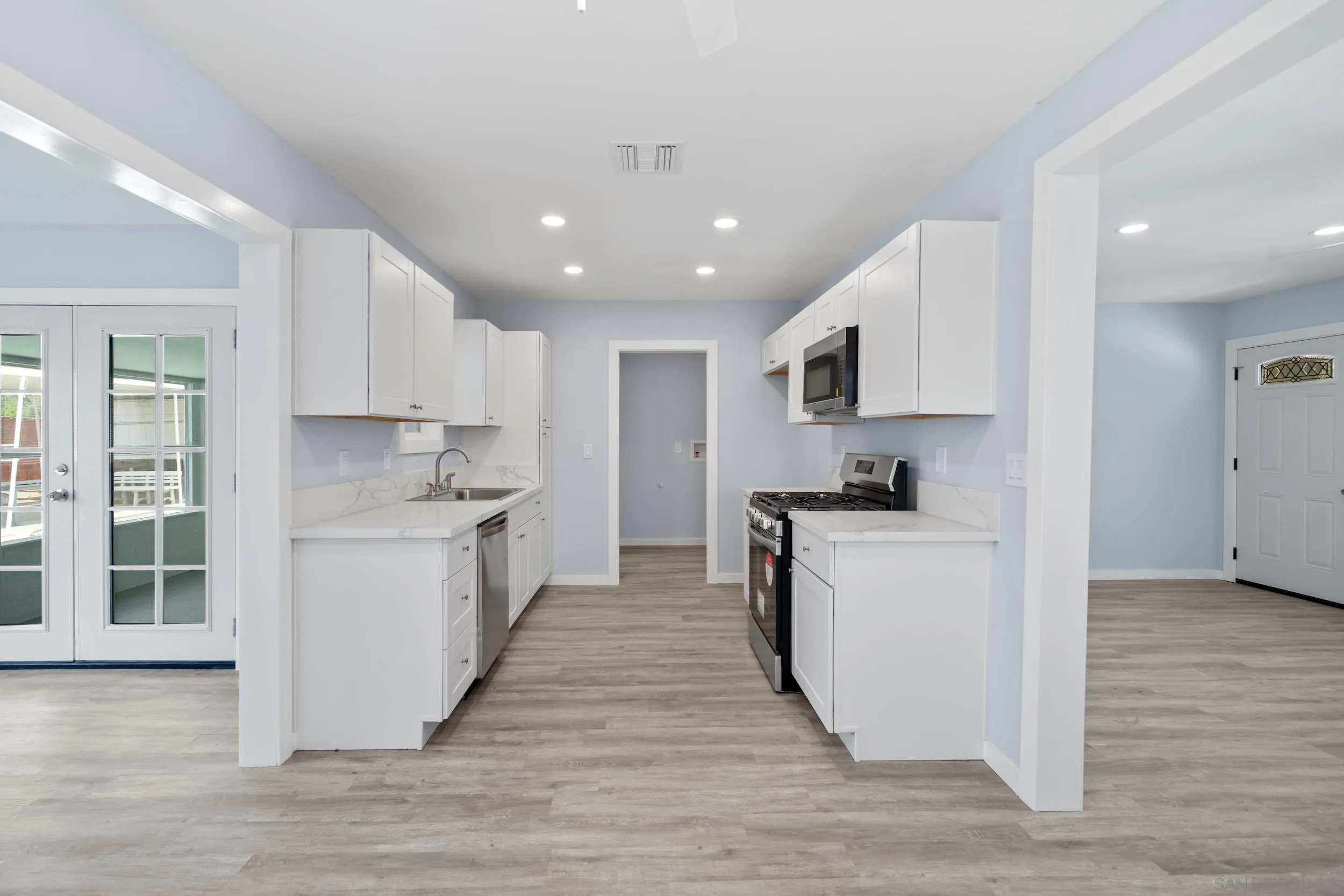 3563 Cannes Avenue Riverside, CA 92501 - Photo 10 of 21 a kitchen with a white stove top oven and white cabinets