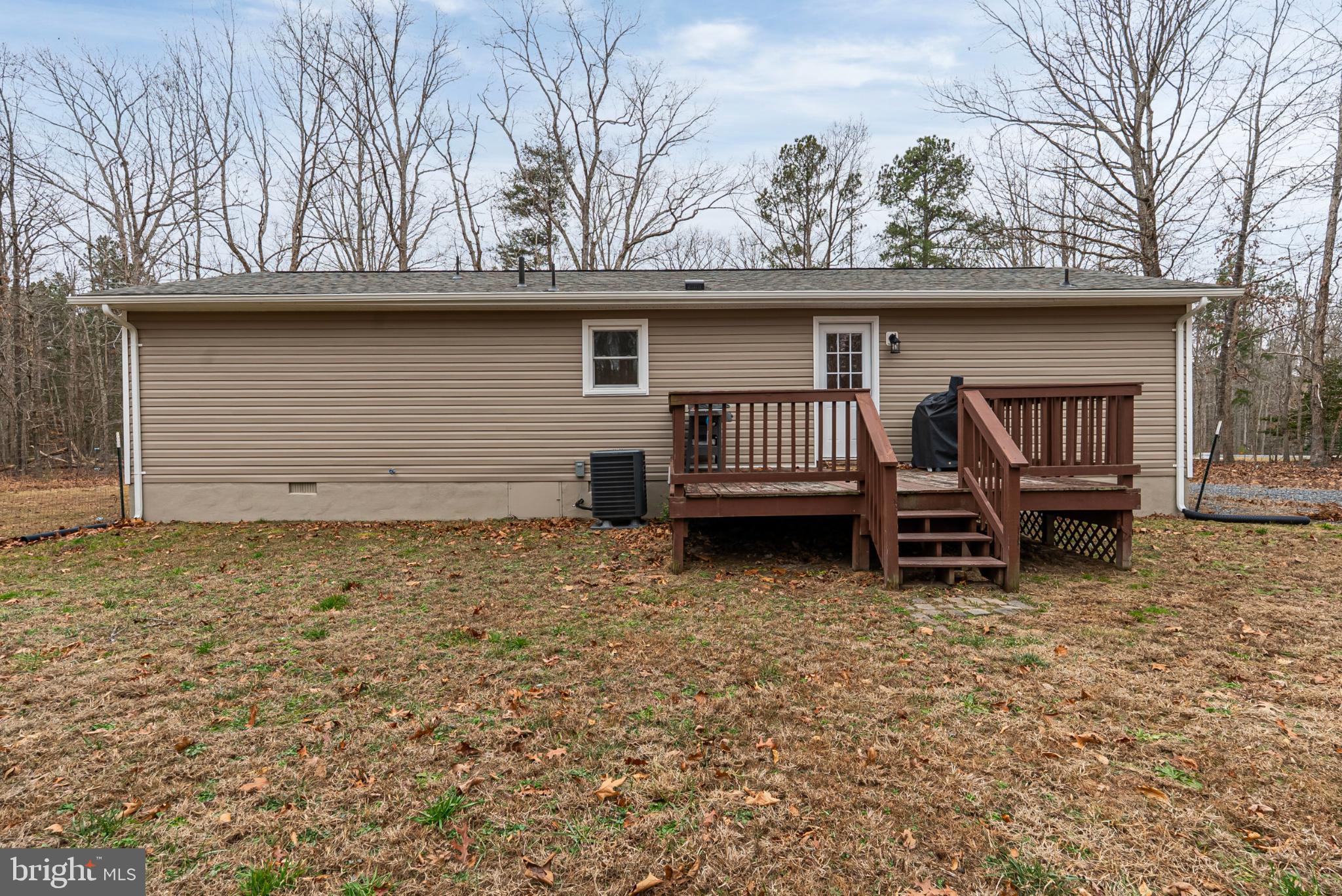 20045 Courtney Road Hanover, VA 23069 - Photo 18 of 21 a view of backyard of house with wooden fence and roof